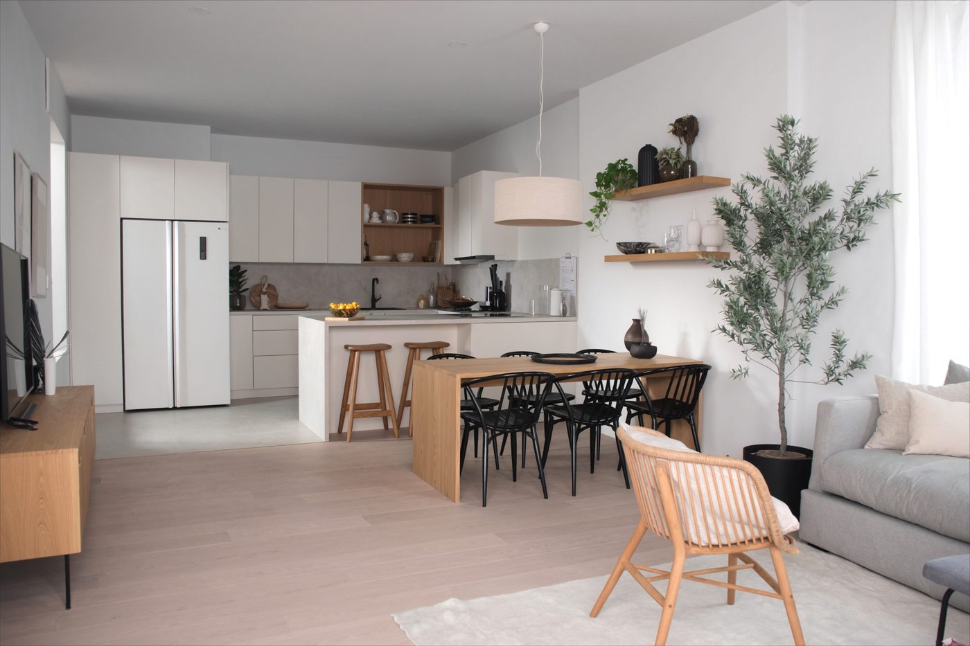 Rendered L-shaped kitchen and living space with dining table