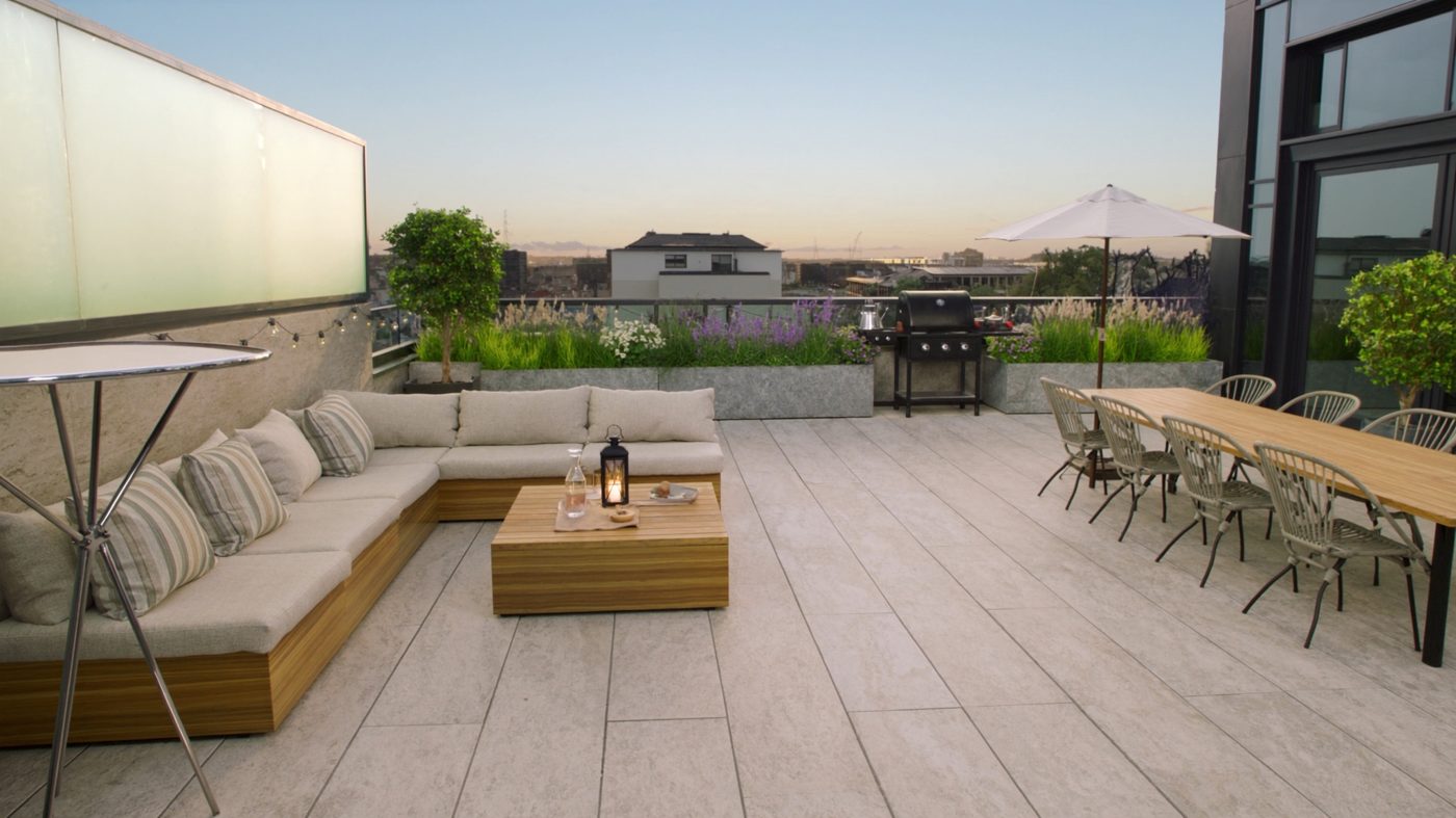 Rendered rooftop terrace with lounge corner, table, grill and parasol
